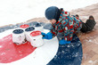 Child playing curling with kettles
