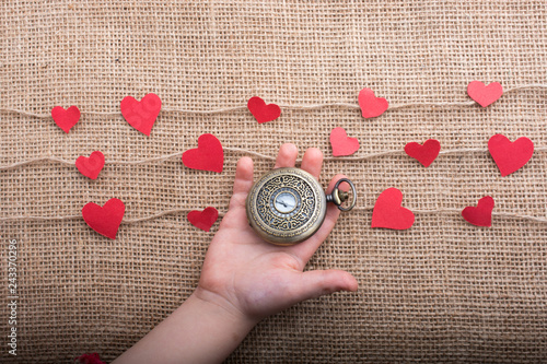 Fotografie, Obraz Love concept with pocket watch and heart shaped icons