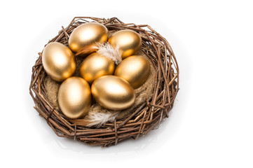 Nest with golden eggs on a white background. Golden Eggs in Nest