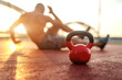 © Dusan Petkovic - Silhouette of shirtless man doing crunches in the court in the morning. Selective focus on kettlebell.