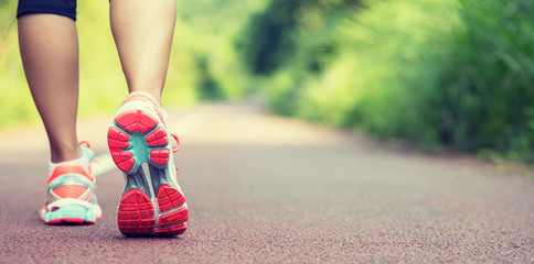 Wall Mural - young woman runner legs ready for running on trail