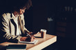 © Yakobchuk Olena - Woman writing important information on paper copybook