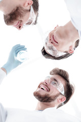 Wall Mural - closeup.a group of scientists looks at the liquid in the beaker