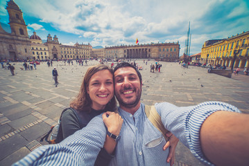 Happy young man taking a selfie photo in Bogota, Colombia. in the main square of the city called Bolivar square