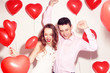 Man with his lovely sweetheart girl dance and have fun at Lover's valentine day. Valentine Couple. Couple very happy, party time, smile, laugh. Background red balloons hearts. Love concept. Crazy.
