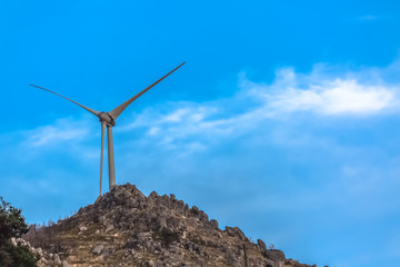 Wall Mural - View of a wind turbine on top of mountains