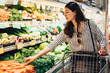 © PR Image Factory - woman in supermarket pushing shopping cart