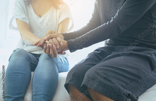 Cuadros en Lienzo Man giving hand to depressed woman,Suicide prevention,Mental health care concept