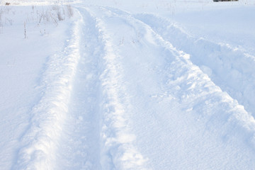 Car tire tracks in fresh snow