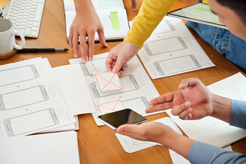 UI creative designer team sketching wireframe layout design for responsive mobile phone application