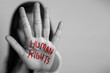 human rights concept. woman raised her hand for dissuade, hand write the word human rights in red color.