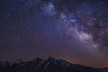 stars and milky way in the clear night sky over main caucasian ridge. mountain landscape and starry 