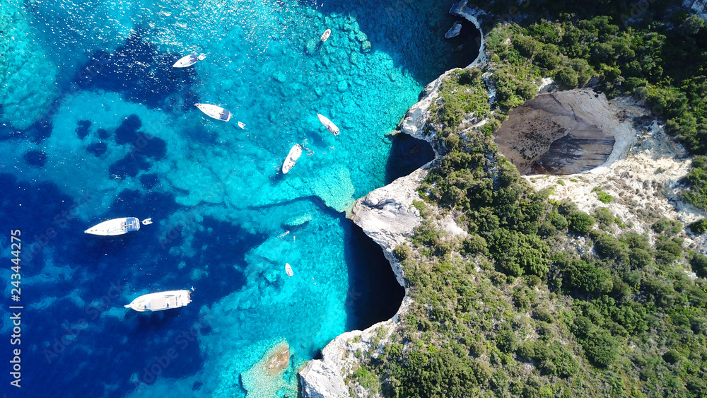 Obraz na płótnie Aerial drone bird's eye view photo of sail boats docked in tropical caribbean paradise bay with white rock caves and turquoise clear sea w salonie