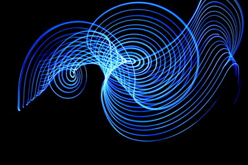 Wall Mural - Light painting, long exposure photography, vibrant electric blue swirls of color against a black background
