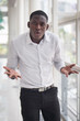 © 9nong - Angry African man shrugging with problem; portrait of angry, upset African black man feeling frustrated with problem, bad issue; African young adult man model