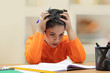 © IndiaPix - Portrait of boy while doing his homework at home