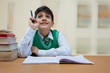 © IndiaPix - School boy is looking up while studying at class