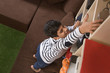 © IndiaPix - Young boy Reaching Up to Take something From a Bookshelf
