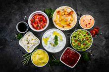 Selection Of Sauces In White Bowls On White Bowls, Top View