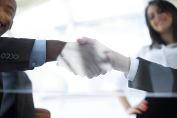 business background. handshake of business partners above the Desk.