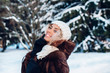 © Elena Kratovich - Happy winter moments of joyful young woman with afro hair, white winter clothes having fun on street in snowing time. Expressing positivity, true brightful emotions