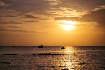 Wall Mural - dramatic sunset clouds reflected on the water sea. tropical landscape at golden hour