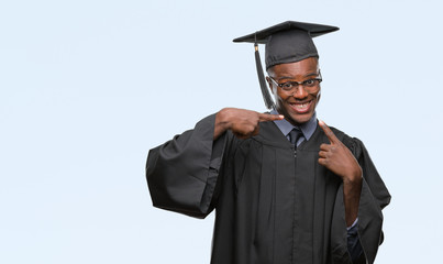 Poster - Young graduated african american man over isolated background smiling confident showing and pointing with fingers teeth and mouth. Health concept.