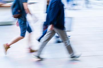 Wall Mural - people walking in the city in motion blur