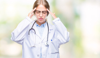 Poster - Beautiful young blonde doctor woman wearing medical uniform over isolated background with hand on head for pain in head because stress. Suffering migraine.