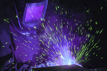  Welder On The Production Of Weld Metal. Sparks Fly, Smoke