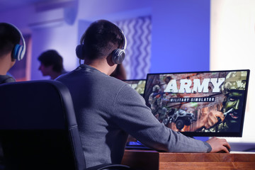 Wall Mural - Young people playing video games at tournament