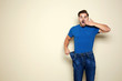 © New Africa - Fit man in oversized jeans on color background, space for text. Weight loss
