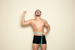 © New Africa - Fit man measuring his waist on color background. Weight loss