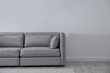 © New Africa - Simple living room interior with comfortable sofa near light wall. Space for text