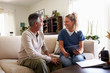 © Monkey Business - Female healthcare worker using a tablet computer with a senior Hispanic man during a home visit