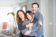 © Krakenimages.com - Beautiful family together. Mother, father and daughter smiling and hugging with love at home.