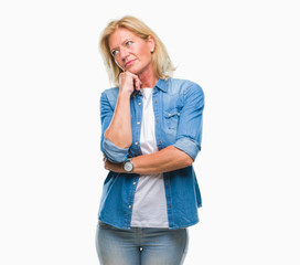 Wall Mural - Middle age blonde woman over isolated background thinking looking tired and bored with depression problems with crossed arms.