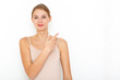 © primipil - Portrait of happy surprised young woman model indicates with fore finger shows place for your advertisement or promotional text.