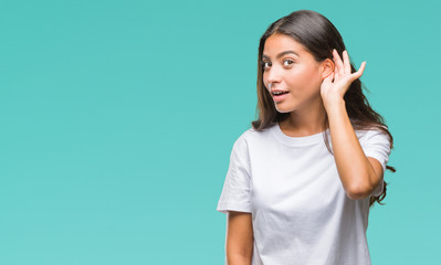 Sticker - Young beautiful arab woman over isolated background smiling with hand over ear listening an hearing to rumor or gossip. Deafness concept.