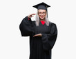 © Krakenimages.com - Young blonde woman wearing graduate uniform over isolated background gesturing with hands showing big and large size sign, measure symbol. Smiling looking at the camera. Measuring concept.