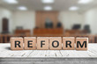 Reform sign on a desk with a blurry background