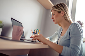 Beautiful young woman working at home office