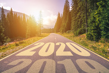 Empty Asphalt Road And New Year 2020 Concept. Driving On An Empty Road In The Mountains To Upcoming 2020 And Leaving Behind Old 2019. Concept For Success And Passing Time.