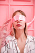 © primipil - Young girl blindfolded pink background
