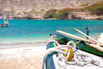 Old fishing boat on the shore. Boat with nets waiting for fishermen on the beach of Cape Verde.