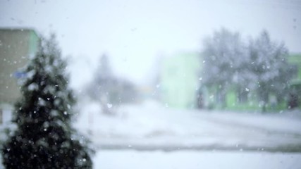 Wall Mural - blurred background of falling snow in the winter on the road in the village.