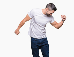 Handsome man wearing white t-shirt over white isolated background Dancing happy and cheerful, smiling moving casual and confident listening to music