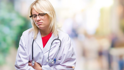 Sticker - Young beautiful blonde doctor woman wearing medical uniform over isolated background with hand on stomach because nausea, painful disease feeling unwell. Ache concept.