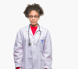 Sticker - Young afro american doctor woman over isolated background skeptic and nervous, frowning upset because of problem. Negative person.