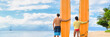 Two people young couple surfers standing with surfboards on hawaii Kaanapali beach after surf class. Fun surfing sport activity on Maui touristic beach for summer vacations. Banner panorama.